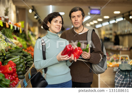Couple chooses cucumbers and red peppers 133188631
