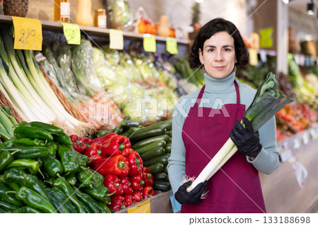 Woman presents fresh celery, best option of vegetables from local and imported producers Woman presents fresh celery, best option of vegetables from local and imported producers 133188698