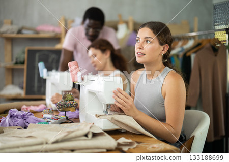 Young girl working with sewing-machine during dressmaking courses Young girl working with sewing-machine during dressmaking courses 133188699