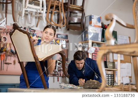 Portrait of skillful repair woman carpenter renovating chair furniture using tools in woodwork studio Portrait of skillful repair woman carpenter renovating chair furniture using tools in woodwork studio 133188730
