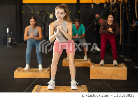 Young woman stepping on box at Crossfit workout 133188922