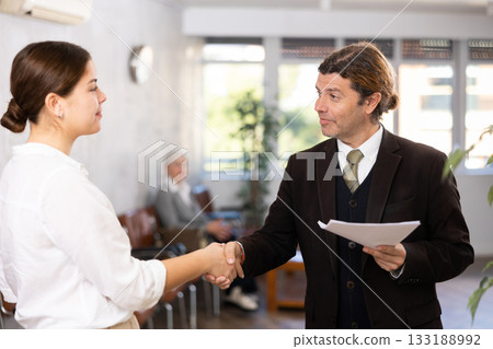 Young businesswoman shaking hands with man executive 133188992