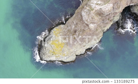 Aerial view of a rocky coastline with turquoise water. Media Aerial view of a rocky coastline with turquoise water. Media 133189275