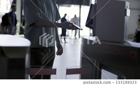People passing through turnstile using smartphone nfc technology. Media People passing through turnstile using smartphone nfc technology. Media 133189323