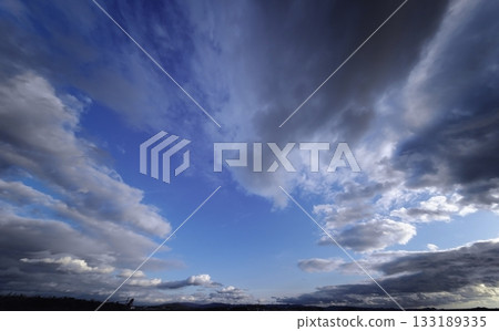 Dynamically spread clouds in the evening sky and cityscape, winter, ultra-wide angle, sky-focused, 240206pm Dynamically spread clouds in the evening sky and cityscape, winter, ultra-wide angle, sky-focused, 240206pm 133189335