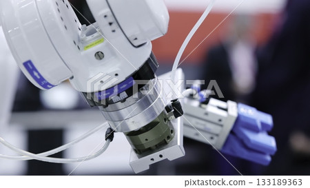 Robotic arm picking and placing metal grid in modern factory. Media Robotic arm picking and placing metal grid in modern factory. Media 133189363