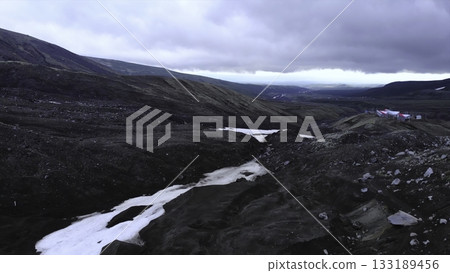 Volcanic mountain valley with melting snow. Media 133189456