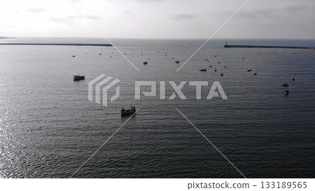 Aerial view of fishing boats floating in the calm ocean. Media 133189565