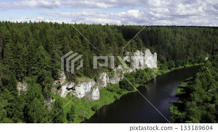 Chusovaya river flows along the picturesque rocks and coniferous forest Chusovaya river flows along the picturesque rocks and coniferous forest 133189604