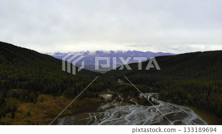 Braided river flowing through autumn forest valley. Media Braided river flowing through autumn forest valley. Media 133189694