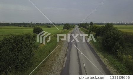 Aerial view of a country road leading to the horizon. Clip Aerial view of a country road leading to the horizon. Clip 133189696