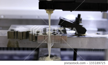 Electrical discharge machining cutting metal piece with sparks. Media 133189725