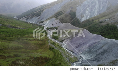 Turquoise river flowing through picturesque valley. Media Turquoise river flowing through picturesque valley. Media 133189757
