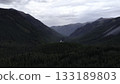 Breathtaking valley panning showcasing majestic mountains and lush forests. Media 133189803