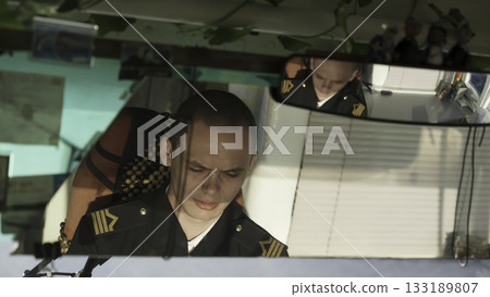 Young man in uniform sitting inside a vehicle. Clip 133189807