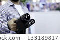 Engineer holding and connecting electric car charger. Media 133189817