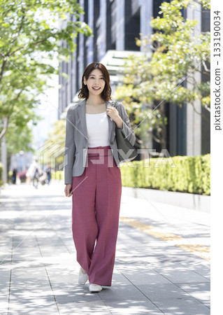 一名 30 多歲的女商人走在辦公區 133190034