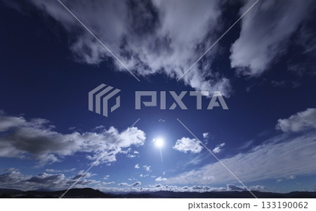 Dynamically spread clouds in the refreshing blue sky. Winter. Ultra-wide angle. Sky-focused. 240226am. 133190062