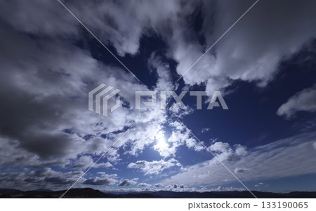 Dynamically spread clouds in the refreshing blue sky. Winter. Ultra-wide angle. Sky-focused. 240226am. 133190065