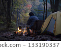 A man enjoying solo camping at dusk 133190337
