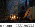 A man enjoying solo camping at dusk 133190338