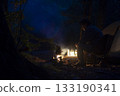 A man enjoying solo camping at dusk 133190341