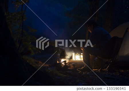 A man enjoying solo camping at dusk A man enjoying solo camping at dusk 133190341