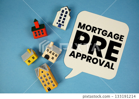 Mortgage Pre-Approval text with house models on blue background Mortgage Pre-Approval text with house models on blue background 133191214