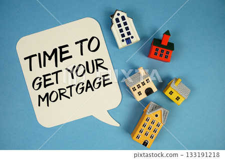 Time To Get Your Mortgage text with house models on blue background 133191218