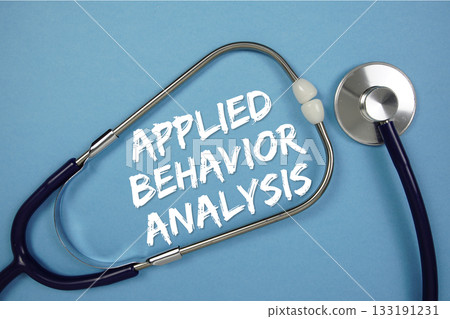 Applied Behavior Analysis text with stethoscope on blue background 133191231