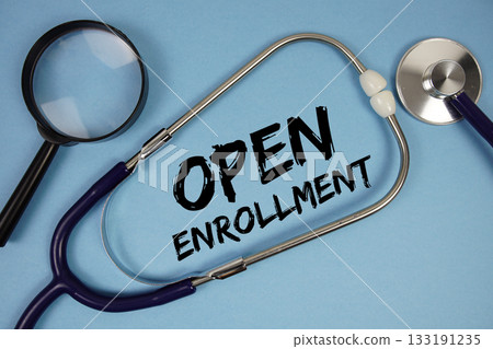 Open Enrollment text with Stethoscope and magnifying glass on blue background 133191235