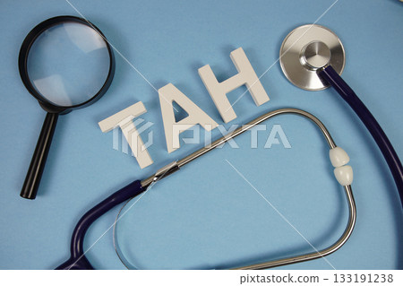 TAH abbreviation of Total Abdominal Hysterectomy alphabet letters with magnifying glass and stethoscope on blue background TAH abbreviation of Total Abdominal Hysterectomy alphabet letters with magnifying glass and stethoscope on blue background 133191238