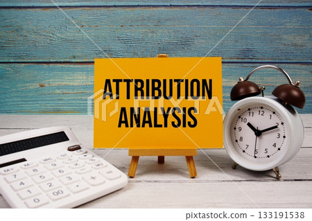Attribution Analysis text written on paper card with calculator and alarm clock on wooden background Attribution Analysis text written on paper card with calculator and alarm clock on wooden background 133191538