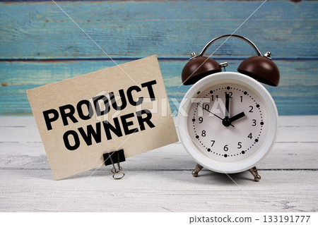 Product Owner text written on paper card with alarm clock on wooden background Product Owner text written on paper card with alarm clock on wooden background 133191777