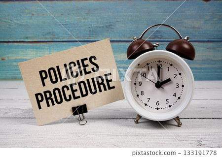 Policies Procedure text written on paper card with alarm clock on wooden background Policies Procedure text written on paper card with alarm clock on wooden background 133191778