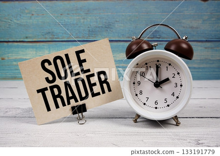 Sole Trader text written on paper card with alarm clock on wooden background Sole Trader text written on paper card with alarm clock on wooden background 133191779