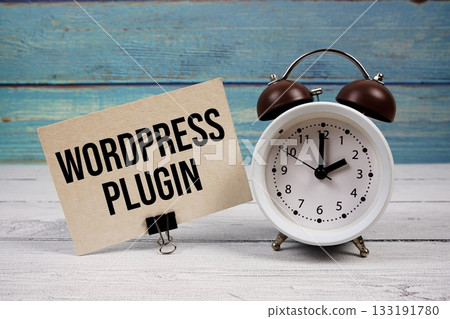 Wordpress Plugin text written on paper card with alarm clock on wooden background Wordpress Plugin text written on paper card with alarm clock on wooden background 133191780