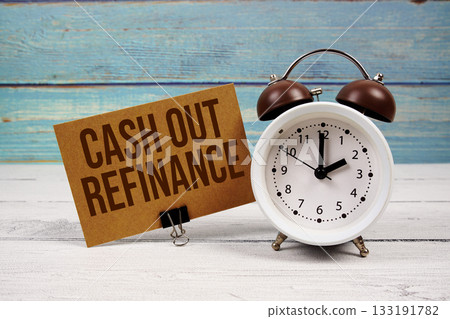 Cash Out Refinance text written on paper card with alarm clock on wooden background 133191782