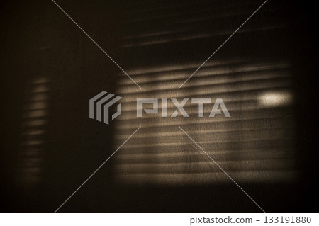 Shadow Stripes From Blinds On Wall, A striking ad photo of shadow stripes from blinds cast on a wall, light beams slicing softly, perfect for modern interior campaign or minimalist art documentary. 133191880