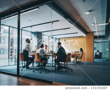 Men and women chatting in a conference room 133191887