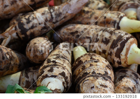 Fresh taro roots displayed at a vibrant local market in the heart of autumn 133192018
