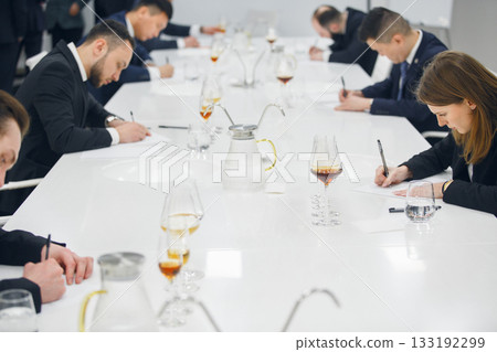 Sommelier association during wine tasting, wine school. Wine waiters degustates various alcohol beverages on training.  133192299