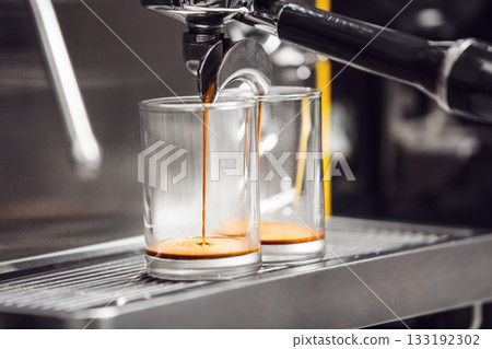 Close-Up View of Espresso Extraction Process in Modern Coffee Machine at Cafe Close-Up View of Espresso Extraction Process in Modern Coffee Machine at Cafe 133192302