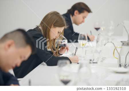 Sommelier association during wine tasting, wine school. Wine waiters degustates various alcohol beverages on training. Blind wine tasting. Sommelier association during wine tasting, wine school. Wine waiters degustates various alcohol beverages on training. Blind wine tasting. 133192310