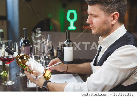 Wine steward expertises alcoholic beverage. Closeup. Wine steward expertises alcoholic beverage. Closeup. 133192332