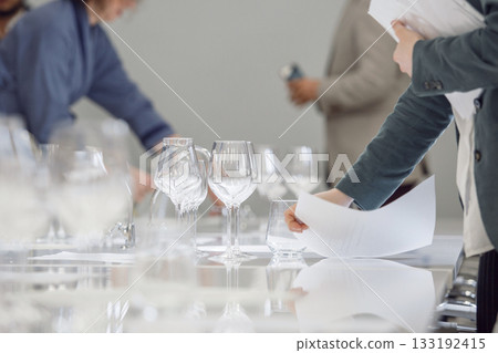 Layout of wine glasses on the table, preparing for the tasting of alcoholic beverages. Preparation to blind wine tasting for beginners sommelier. Wine school, winemaking lecture. Layout of wine glasses on the table, preparing for the tasting of alcoholic beverages. Preparation to blind wine tasting for beginners sommelier. Wine school, winemaking lecture. 133192415