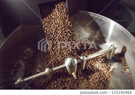 Freshly Roasted Coffee Beans Unloading Into Rotating Cooling Drum Freshly Roasted Coffee Beans Unloading Into Rotating Cooling Drum 133192468