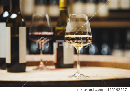 Close-Up of Wine Glasses on Wooden Barrel in Cellar Close-Up of Wine Glasses on Wooden Barrel in Cellar 133192517