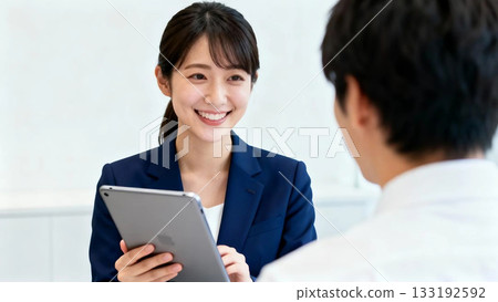 A consultation scene between a male customer and a female staff member who provides a sense of security through polite customer service A consultation scene between a male customer and a female staff member who provides a sense of security through polite customer service 133192592