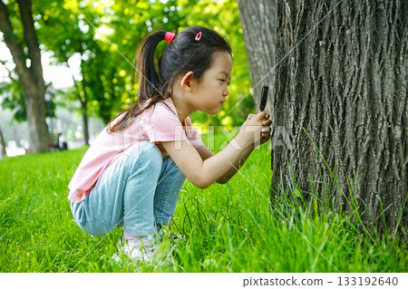 Kid Asian Girl Examining Insects on Tree Using Magnifying Glass 133192640